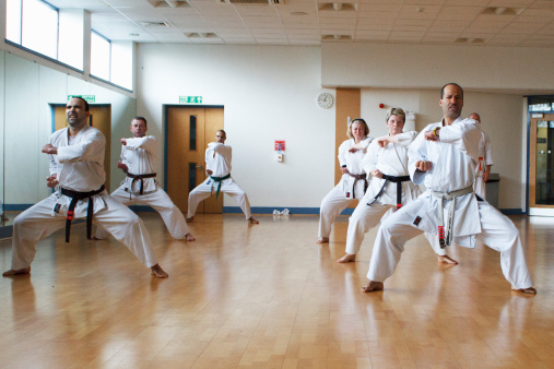 Men and women in martial arts class
